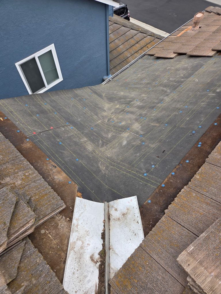 removing old roof tiles during repair in Carmel Valley