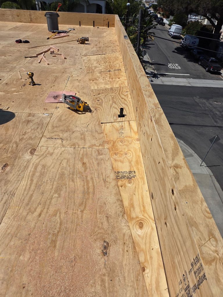 cricket being framed and sheeted along the parapet edge