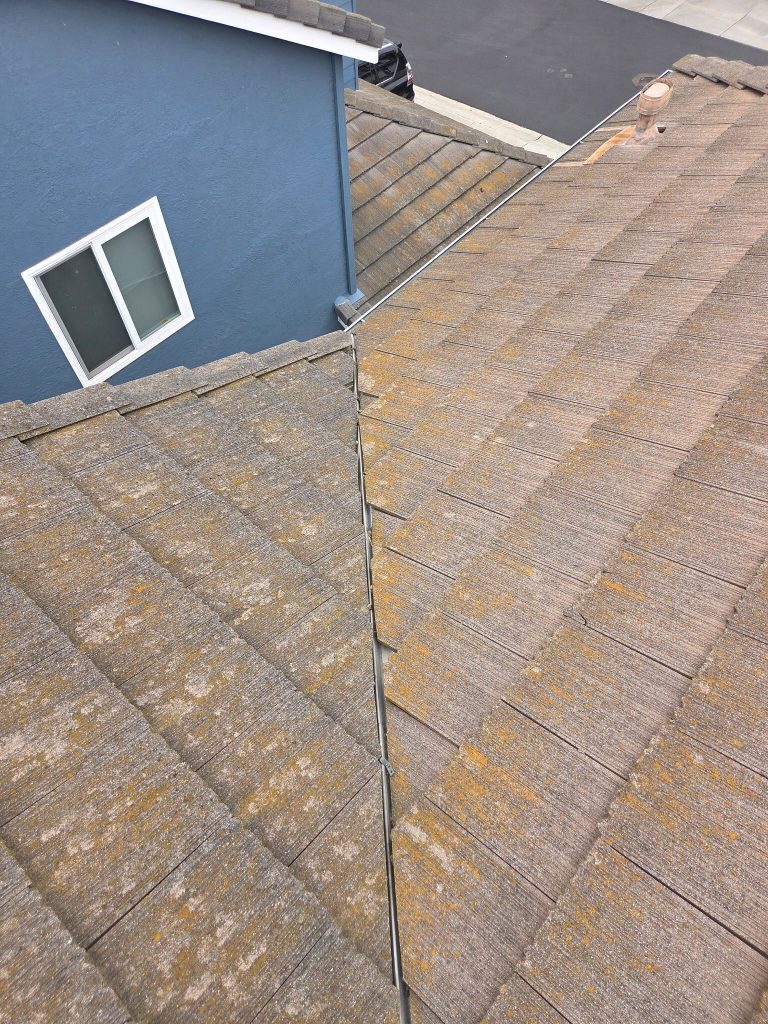 completed tile roof repair in California showing restored valley and reinstalled tiles