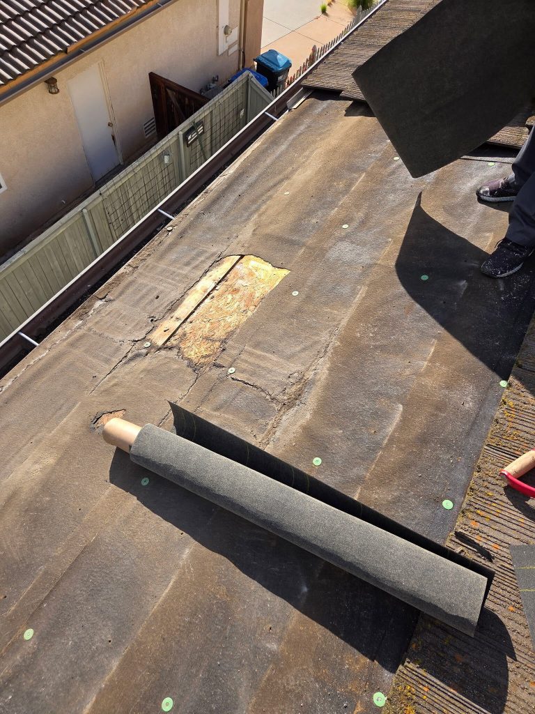 existing roofing materials removed during a tile roof repair project in santee, exposing the area affected by a roof leak