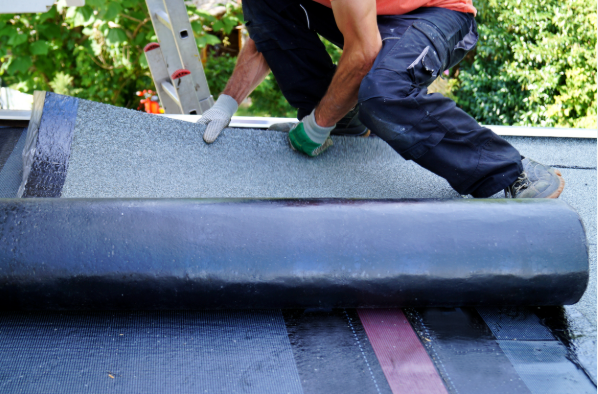 roofer installing a roll roofing membrane for a san diego flat roof replacement