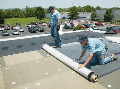 ford roofing crew installing a built-up flat roof membrane for a san diego building