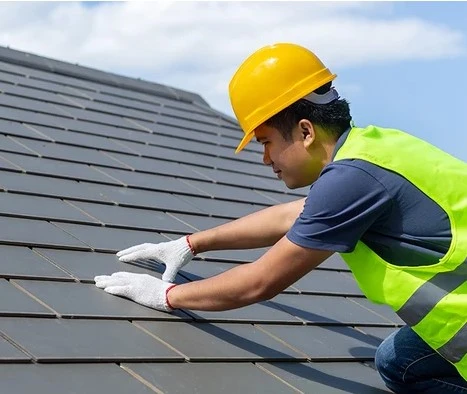 an licensed roofer inspecting solar roof in san diego